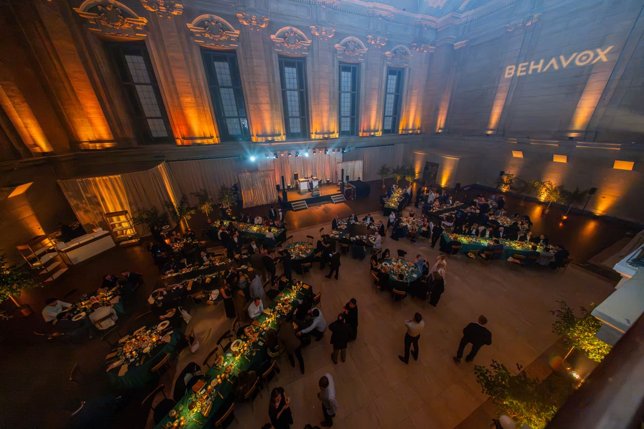 The gala hall from above: tables, the stage and the Behavox logo on the wall